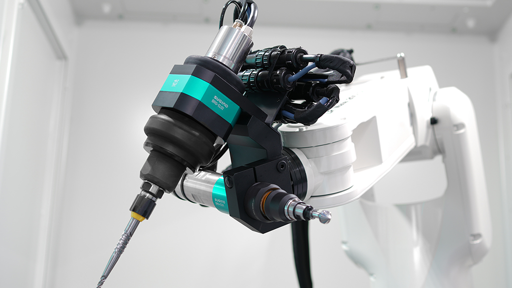 Two spindles and tools inside the RDM-S robotic deburring cell from Sugino